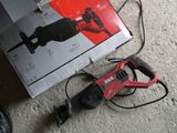 a box of tools sitting on the floor next to a corded drill