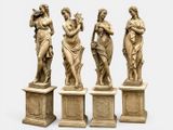 quatre statues de femmes tenant des fleurs, posées sur des socles, sur fond blanc