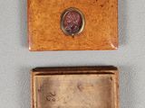 two small wooden boxes with a wax seal on top of them