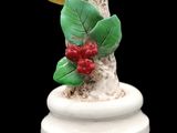 a figurine of a bird perched on a tree