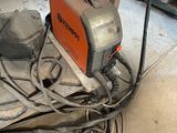 a machine that is sitting on the ground in the garage