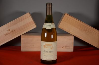a bottle of wine sitting on a table next to two wooden boxes