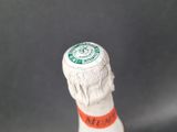 a close up of a bottle of beer with a cap on it