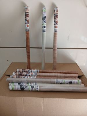 several rolls of wrapping paper sitting on top of a cardboard box