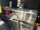a stainless steel sink in the corner of a kitchen