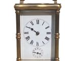 a small clock with roman numerals on the face