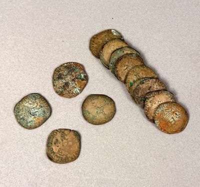 several pieces of ancient roman coins sitting on top of a white surface
