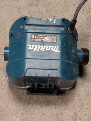 a blue electric device that is on the ground