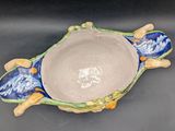 a bowl with a fish design on it on a table