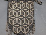 a small bag with a chain hanging from it ' s side