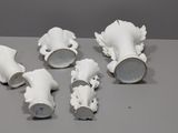 five white vases sitting on top of a table