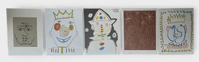 several paintings of different shapes and sizes are hanging on a wall