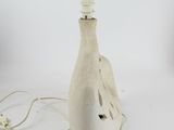 a white bottle with a light attached to it