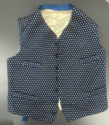 a blue vest with white polka dots on it