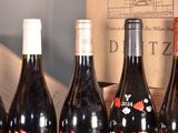 several bottles of wine are lined up on a table