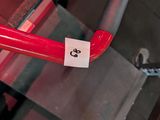 a red fire hydrant that has a sticker on it