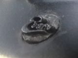 a skull on the hood of a car in the rain