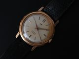 a close up of a watch on a black surface