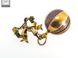a gold and blue ball with a chain attached to it
