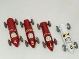 four toy cars sitting next to each other on a table