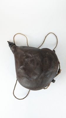 an overhead view of a brown leather bag with two handles