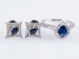 a close up of two rings and a pair of earrings