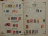 an open book with stamps on it on a table