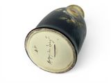 a black and white vase with writing on it