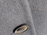 close up of a button on a gray coat