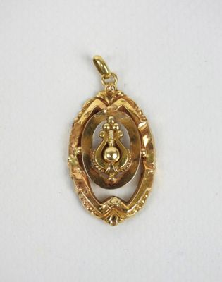 an image of a gold plated pendant with an image of a woman in a circle