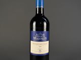 a bottle of wine sitting on top of a table next to a bottle of wine