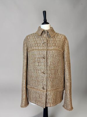 a brown jacket on a mannequin mannequin stand
