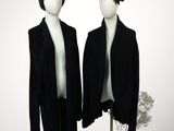 pair of mannequins dressed in black clothing and hats on display
