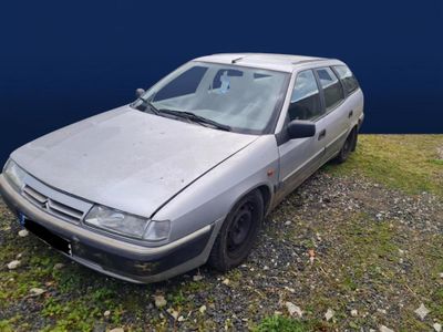 a silver car that is parked on the side of the road