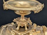 a gold vase that is sitting on a table