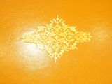 an image of a close up of an orange box with a gold design
