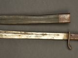 two old knives sitting on top of a table next to each other