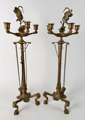 pair of antique brass candelabs with birds on them