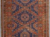 tapis persan ancien à motifs bleus et rouges