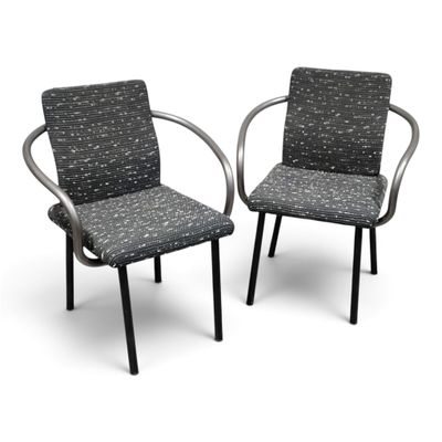 pair of black and white patterned chairs with arms and backrests