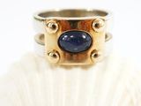 a picture of a ring with a blue stone on it