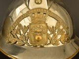 a silver helmet with a gold crest on it