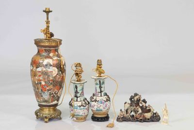 three vases and two other items sitting on a table