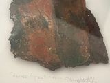 a picture of a piece of rock with writing on it