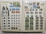 an open book with stamps on it on a table