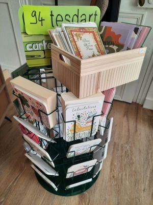 a stack of books in a basket on the floor