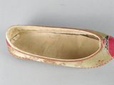 an old pair of slippers with a red and yellow design on them