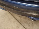 a close up of a car ' s bumper with a denting on it