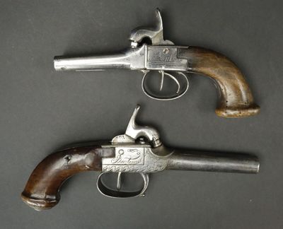 a pair of colt colt colt pistols with wooden grips and wooden grips