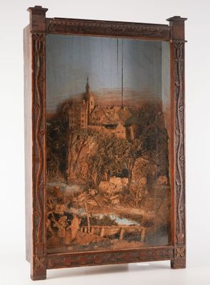 une vieille photo représentant un tableau représentant un château, dans un cadre en bois